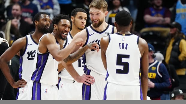 Feb 14, 2024; Denver, Colorado, USA; Sacramento Kings guard Malik Monk (0) and forward Domantas Sabonis (10) and guard De'Aaron Fox (5) react in the fourth quarter against the Denver Nuggets at Ball Arena. Mandatory Credit: Ron Chenoy-USA TODAY Sports